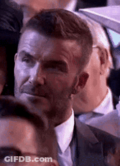Man In Suit Making Funny Face In Crowd GIF