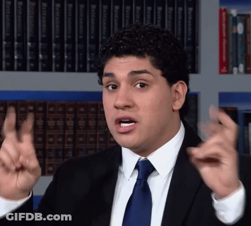 Man In Suit Making Funny Face In Front Of Bookshelf With Bible GIF