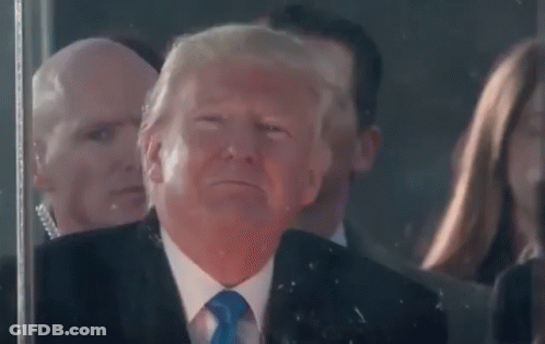 Man In Suit Making Funny Face In Front Of Crowd GIF