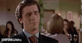 Man In Suit Making Funny Face In Front Of Crowd GIF