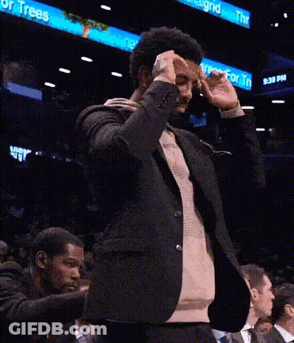 Man In Suit Making Funny Face In Stands GIF