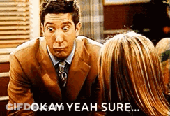 Man In Suit Making Funny Face Next To Woman GIF