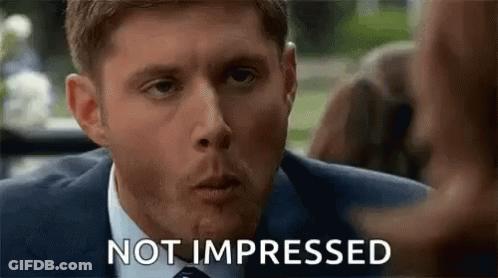 Man In Suit Making Funny Face Not Impressed GIF
