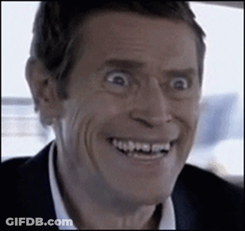 Man In Suit Making Funny Face Smiling GIF