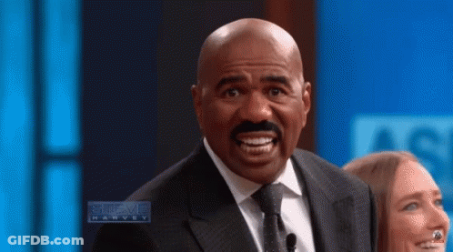 Man In Suit Making Funny Face Talking To Woman GIF