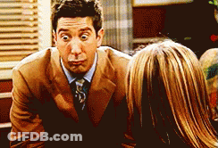 Man In Suit Making Funny Face Talking To Woman GIF
