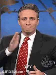 Man In Suit Making Funny Face With Thumbs Up GIF