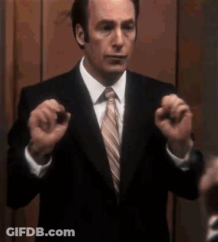 Man In Suit Making Gesture GIF