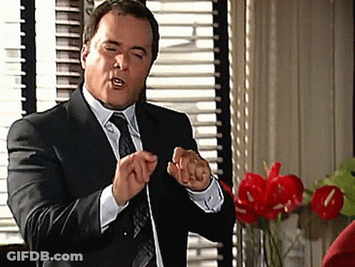 Man In Suit Making Hand Gesture GIF