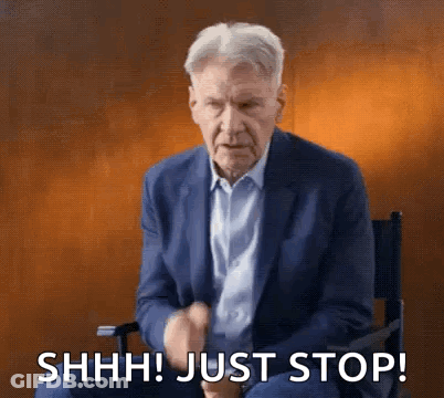 Man In Suit Making Shhh Gesture GIF