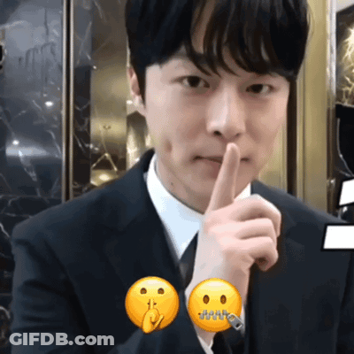 Man In Suit Making Shhh Gesture GIF