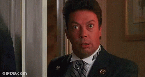 Man In Suit Making Surprised Face In Doorway GIF