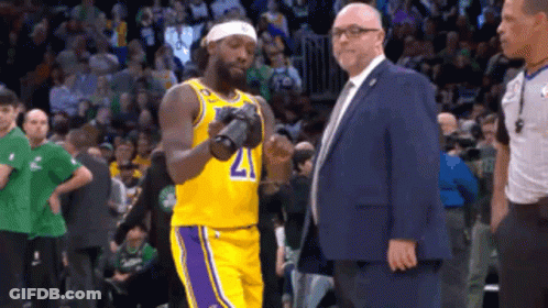 Man In Suit Next To Basketball Player 21 GIF