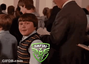 Man In Suit Next To Boy In Striped Vest In Crowd GIF