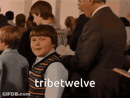 Man In Suit Next To Boy In Striped Vest GIF
