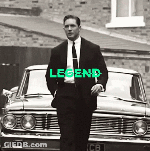 Man In Suit Next To Car With Legend GIF