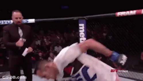 Man In Suit Next To Fighter In Cage GIF