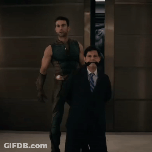 Man In Suit Next To Man In Costume GIF