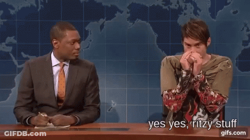 Man In Suit Next To Man In Green Shirt With Tattoo GIF