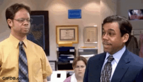 Man In Suit Next To Man In Yellow Shirt GIF