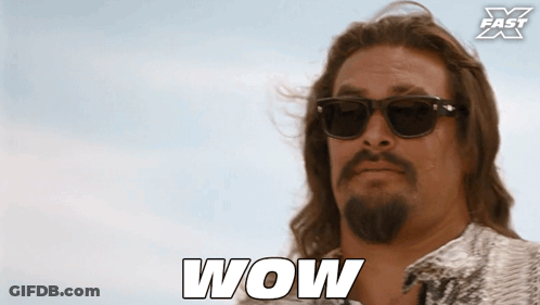 Man In Suit Next To Shirtless Man GIF