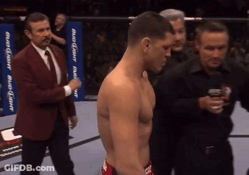 Man In Suit Next To Shirtless Man GIF