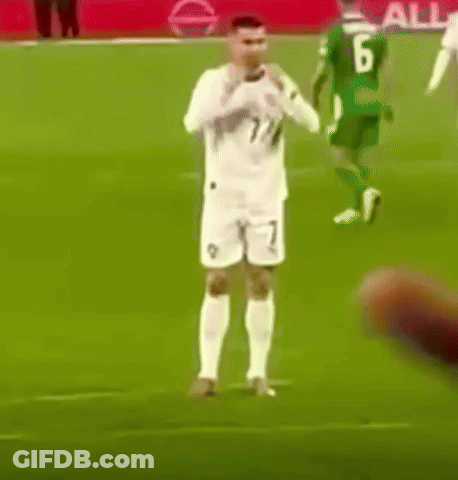 Man In Suit Next To Soccer Jersey Man GIF