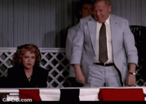 Man In Suit Next To Woman In Black Dress GIF