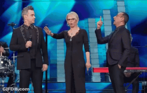 Man In Suit Next To Woman In Black Dress And Man In Suit GIF