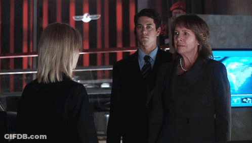 Man In Suit Next To Woman In Black Dress GIF
