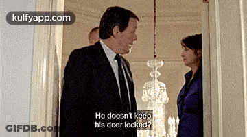 Man In Suit Next To Woman In Blue Suit GIF