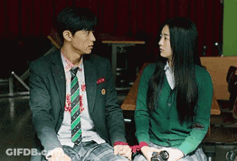 Man In Suit Next To Woman In Green Sweater GIF
