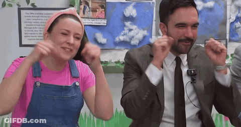 Man In Suit Next To Woman In Overalls And Pink Shirt GIF