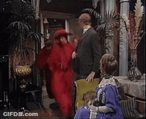 Man In Suit Next To Woman In Red Dress GIF