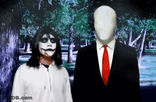 Man In Suit Next To Woman In Scary Costume GIF
