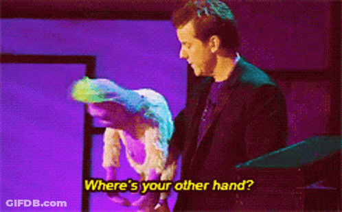 Man In Suit Next To Woman In White Dress Saying Where's Your Other Hand GIF