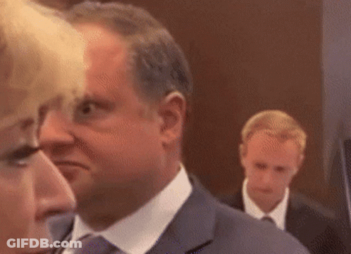 Man In Suit Next To Woman In White Shirt GIF