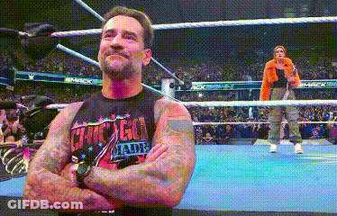 Man In Suit Next To Wrestler GIF