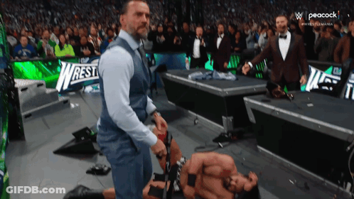 Man In Suit Next To Wrestler GIF