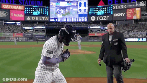 Man In Suit On Baseball Field With Gatorade Scoreboard GIF