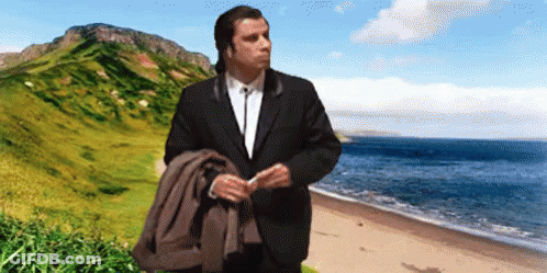 Man In Suit On Beach With Mountain GIF