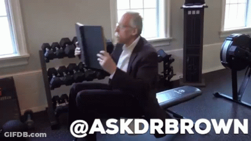 Man In Suit On Gym Bench Holding Book Askdrbrown GIF
