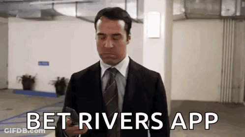 Man In Suit On Phone In Parking Garage GIF