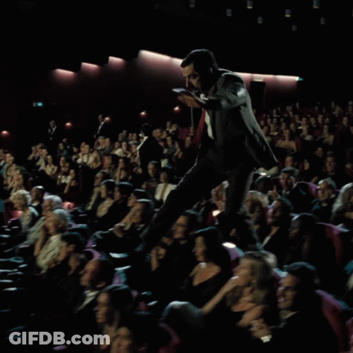 Man In Suit On Podium Before Crowd GIF