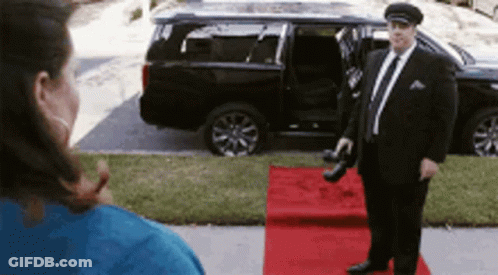 Man In Suit On Red Carpet In Front Of Car GIF
