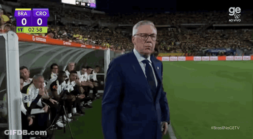Man In Suit On Soccer Field Scoreboard Bra 0 Cro 0 GIF