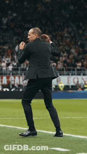Man In Suit On Soccer Field With La Calcio Sign GIF