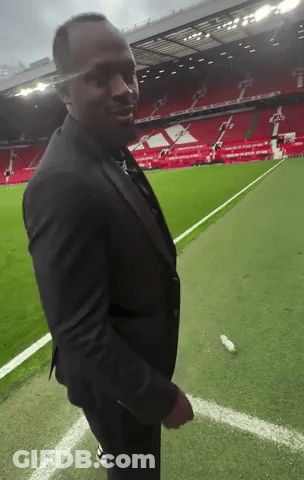 Man In Suit On Soccer Field GIF
