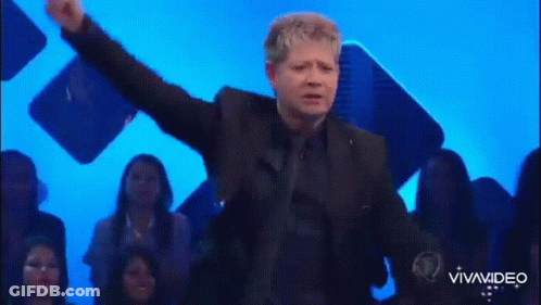 Man In Suit On Stage Arms Outstretched GIF