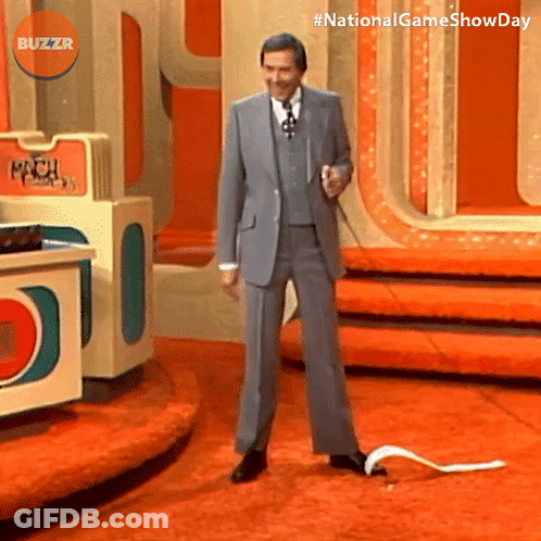 Man In Suit On Stage With Buzzr Logo GIF